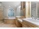 Primary bathroom with decorative shower, vanities and separate bathtub at 3025 Bentwillow Dr, Fuquay Varina, NC 27526