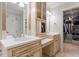 Main bathroom offers and sinks, ample lighting, and large walk in closet at 3025 Bentwillow Dr, Fuquay Varina, NC 27526
