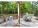 Outdoor patio space with a built-in grill, dining area, and lush greenery in the backyard at 3025 Bentwillow Dr, Fuquay Varina, NC 27526