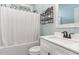Bathroom featuring a combined shower and tub and a sleek white vanity with modern fixtures at 303 Godwin St, Selma, NC 27576