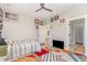 This vibrant bedroom features hardwood floors, natural light, a ceiling fan and fun decor at 303 Godwin St, Selma, NC 27576