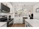 Updated kitchen with stainless steel appliances, white countertops, eat-in island, and open floor plan at 303 Godwin St, Selma, NC 27576