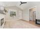 Bright living room with vaulted ceiling, neutral paint, luxury vinyl plank flooring and fireplace with mantle at 303 Godwin St, Selma, NC 27576