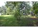 Large grassy backyard surrounded by mature trees at 3204 Friar Tuck Rd Rd, Raleigh, NC 27610