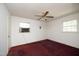 Bright bedroom with a ceiling fan, two windows offering natural light, and a cozy carpeted floor at 3204 Friar Tuck Rd Rd, Raleigh, NC 27610