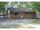 Charming brick single story house surrounded by mature trees at 3204 Friar Tuck Rd Rd, Raleigh, NC 27610