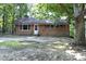 Charming brick single story house surrounded by mature trees at 3204 Friar Tuck Rd Rd, Raleigh, NC 27610