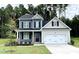 Charming two-story home with a well-maintained lawn and a two-car garage at 348 Danube Dr, Zebulon, NC 27597