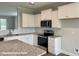 Modern kitchen featuring white cabinets, granite countertops, and stainless steel appliances at 348 Danube Dr, Zebulon, NC 27597