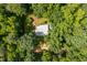 Aerial shot of a home nestled within a densely wooded lot at 3506 Arthur Minnis Rd, Hillsborough, NC 27278