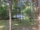 View of the house surrounded by a dense forest, providing privacy and a natural setting at 3506 Arthur Minnis Rd, Hillsborough, NC 27278