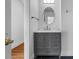 Bathroom features a gray vanity with quartz countertops, modern fixtures, and tiled flooring for a sleek design at 3506 Arthur Minnis Rd, Hillsborough, NC 27278