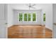 Spacious bedroom with hardwood floors, large windows, and abundant natural light, creating a serene atmosphere at 3506 Arthur Minnis Rd, Hillsborough, NC 27278
