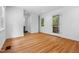 Bright bedroom offers natural light and ample space, featuring hardwood floors, neutral walls, and a backyard view at 3506 Arthur Minnis Rd, Hillsborough, NC 27278