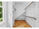 Walk-in closet featuring wooden shelving, natural light, and wooden floors, offering ample storage at 3506 Arthur Minnis Rd, Hillsborough, NC 27278