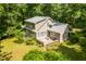 Aerial view of a home surrounded by lush greenery and a large deck, perfect for outdoor living at 3506 Arthur Minnis Rd, Hillsborough, NC 27278