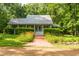 Charming home featuring a brick walkway and a well-maintained front yard with lush greenery at 3506 Arthur Minnis Rd, Hillsborough, NC 27278