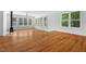 Bright living room with hardwood floors, large windows, and a charming wood-burning stove at 3506 Arthur Minnis Rd, Hillsborough, NC 27278