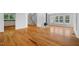 Open-concept living area with hardwood floors, staircase, fireplace, and ample natural light at 3506 Arthur Minnis Rd, Hillsborough, NC 27278