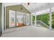 Enclosed porch showcasing access to an indoor living area with views of the surrounding lush greenery at 3506 Arthur Minnis Rd, Hillsborough, NC 27278