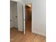 A room showing the doorway to a storage space that is carpeted with insulated walls, neutral paint, and wooden floors at 3506 Arthur Minnis Rd, Hillsborough, NC 27278