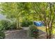 Serene backyard escape with mature trees, lush greenery, mulched beds, and a relaxing hammock at 3601 Lily Orchard Way, Apex, NC 27539