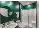 Modern bathroom with green walls, a sleek sink, and a glass-enclosed shower at 3601 Lily Orchard Way, Apex, NC 27539