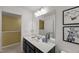 Bathroom featuring a dark vanity, ample counter space, and decorative accents at 3601 Lily Orchard Way, Apex, NC 27539