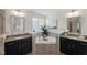Bathroom featuring a large bathtub, natural lighting, and granite countertops at 3601 Lily Orchard Way, Apex, NC 27539