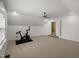 Bonus room features an exercise machine, ceiling fan, neutral carpet, and a doorway leading to more space at 3601 Lily Orchard Way, Apex, NC 27539
