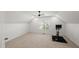 Finished bonus room includes neutral walls and carpet, natural light, and a workout machine at 3601 Lily Orchard Way, Apex, NC 27539
