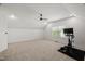 Bonus room boasts a ceiling fan, neutral carpet, a window for natural light, and workout equipment at 3601 Lily Orchard Way, Apex, NC 27539