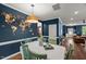 Stylish dining room features a world map accent wall and plenty of natural light at 3601 Lily Orchard Way, Apex, NC 27539