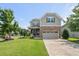 Charming two-story home features a stone facade, manicured lawn, and attached two-car garage at 3601 Lily Orchard Way, Apex, NC 27539