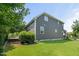 Exterior view of the home showcasing the yard, siding, and surrounding foliage at 3601 Lily Orchard Way, Apex, NC 27539