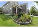Charming front yard featuring a beautiful flower bed with healthy plants and a well-manicured lawn at 3601 Lily Orchard Way, Apex, NC 27539