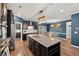 Gourmet kitchen featuring granite countertops, stainless steel appliances, and open dining area at 3601 Lily Orchard Way, Apex, NC 27539