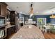 Large kitchen island with granite countertop, pendant lighting, and ample storage space at 3601 Lily Orchard Way, Apex, NC 27539
