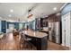 Spacious kitchen island with granite countertop, seating, and stainless steel appliances at 3601 Lily Orchard Way, Apex, NC 27539