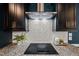 Close-up of the kitchen cooktop with granite counters and subway tile backsplash at 3601 Lily Orchard Way, Apex, NC 27539