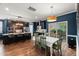 Well-equipped kitchen featuring dark cabinetry, stainless steel appliances, and adjacent dining area at 3601 Lily Orchard Way, Apex, NC 27539
