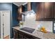 Stylish kitchen features a sleek cooktop, subway tile backsplash, and granite countertops at 3601 Lily Orchard Way, Apex, NC 27539