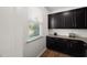 Kitchenette area features dark cabinets, granite countertops, and a bright window at 3601 Lily Orchard Way, Apex, NC 27539