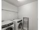 Bright laundry room featuring an Electrolux washer/dryer set and a metal drying rack at 3601 Lily Orchard Way, Apex, NC 27539