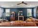 Bright living room featuring a fireplace, large windows and hardwood floors with comfortable seating at 3601 Lily Orchard Way, Apex, NC 27539