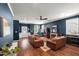 Spacious living room with hardwood floors, leather couches, and a cozy fireplace for gatherings at 3601 Lily Orchard Way, Apex, NC 27539
