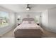 Main bedroom with neutral tones, carpeted floor, ceiling fan, and plenty of natural light at 3601 Lily Orchard Way, Apex, NC 27539