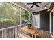 Inviting screened porch featuring a wooden table with bench seating and view of the serene backyard at 3601 Lily Orchard Way, Apex, NC 27539
