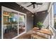 Cozy screened porch with string lights, ceiling fan, and wooden table, perfect for outdoor relaxation at 3601 Lily Orchard Way, Apex, NC 27539