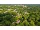 Aerial view of the property showcasing its proximity to the neighborhood and surrounding trees at 429 Carolina Cir, Durham, NC 27707